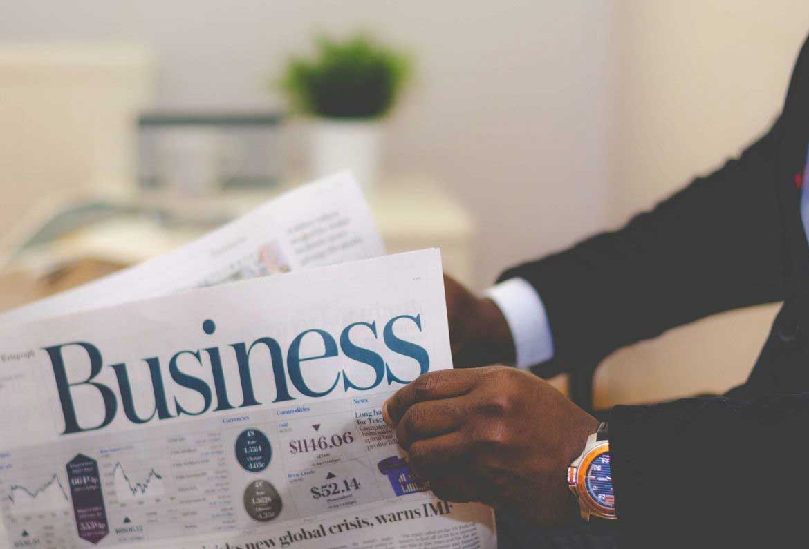 man reading the business section of the newspaper